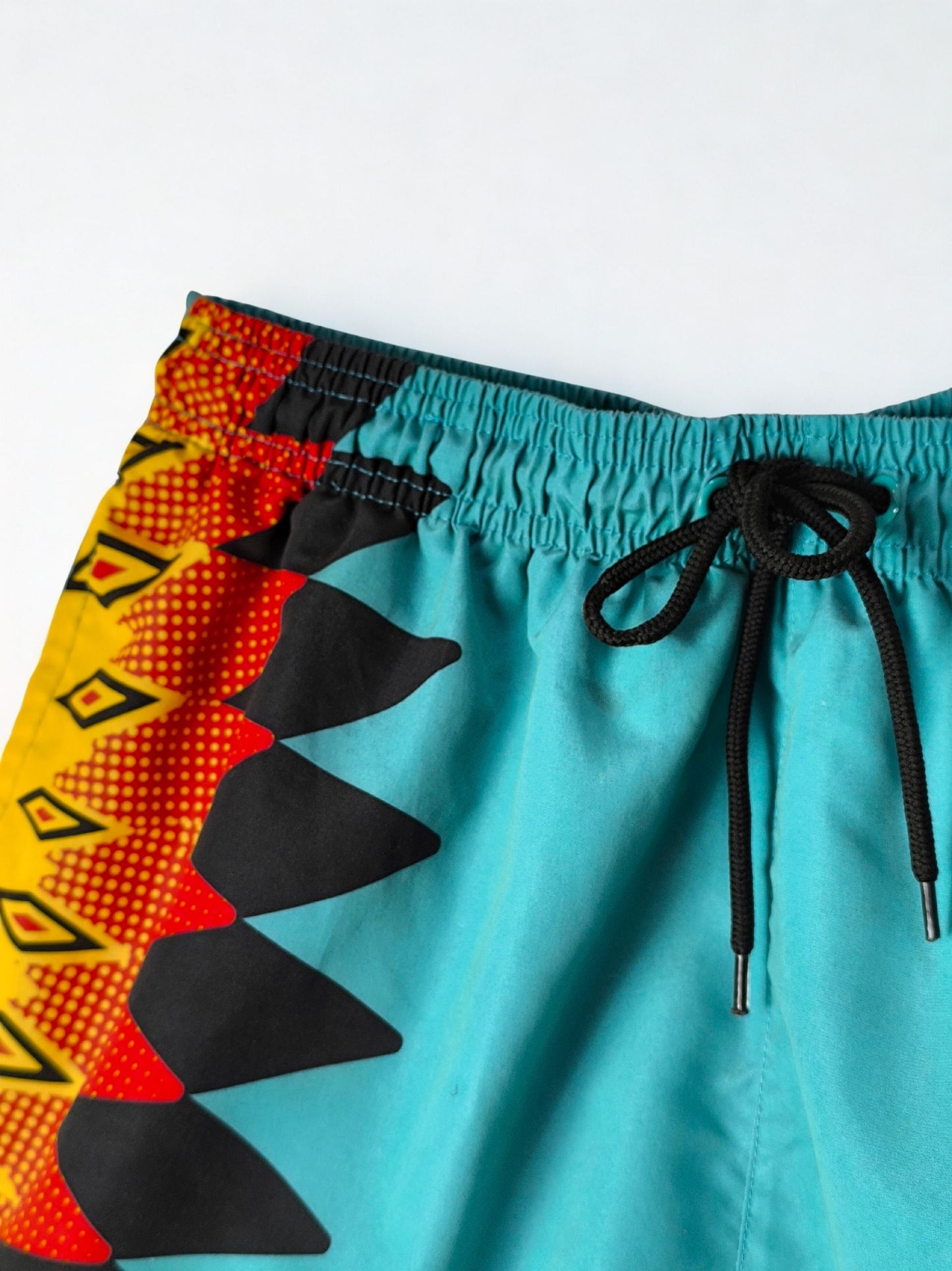 Retro Umbro Swim Shorts – Turquoise with Tribal Flame Print